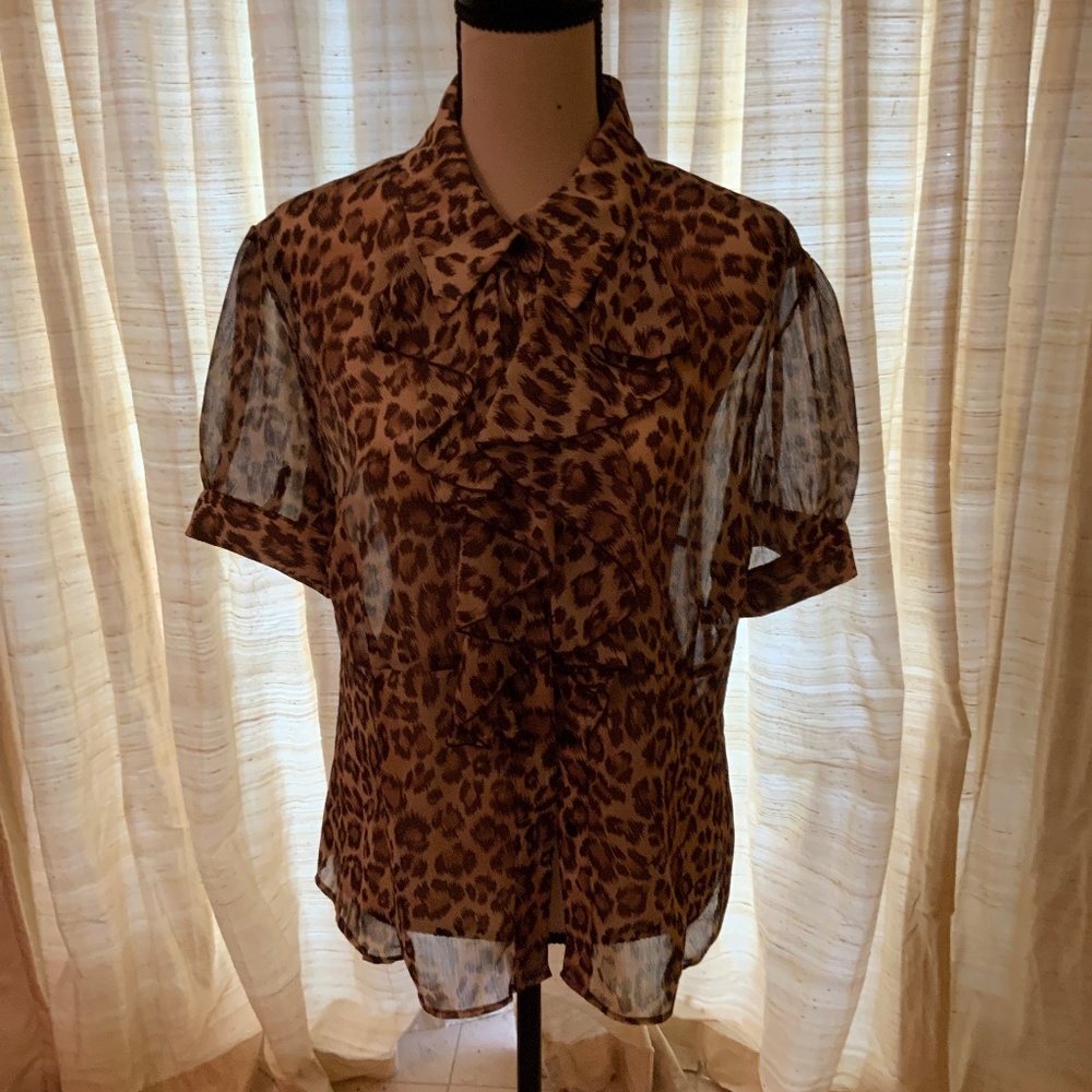 Animal print capped , ruffled blouse.